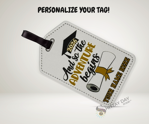Luggage tag with graduation design and "so the adventure begins 2026" text with a name customization option on a white background.