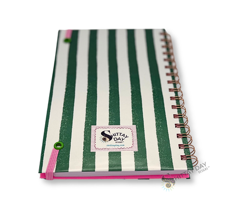 Back cover of the "Balance" wire bound notebook with green and white stripes with small brand logo in striped pink frame featured on a white background