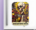 A magnet with a skeletal design with boba drink and the text :suck my boba balls" on a colorful yellow floral background