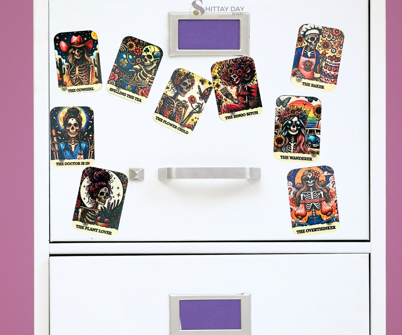 Set of colorful tarot inspired skeleton magnets on a white file cabinet surface.