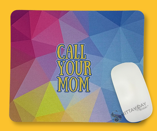 Colorful geometric mouse pad with 'Call Your Mom' text, a white mouse, merchandised on a yellow background