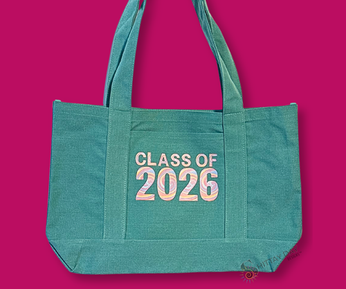 Teal Green pocket tote with tie dye swirl  'Class of 2026' text. Merchandised  on a hot pink background