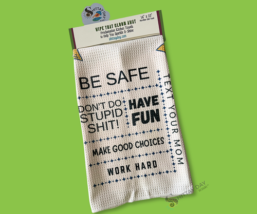 White waffle weave kitchen towel with funny college advice, yellow stars and paper airplanes. Advice text "Be Safe, Have Fun, Don't do stupid shit, Text your Mom, Make good choices, work hard". On a green background.