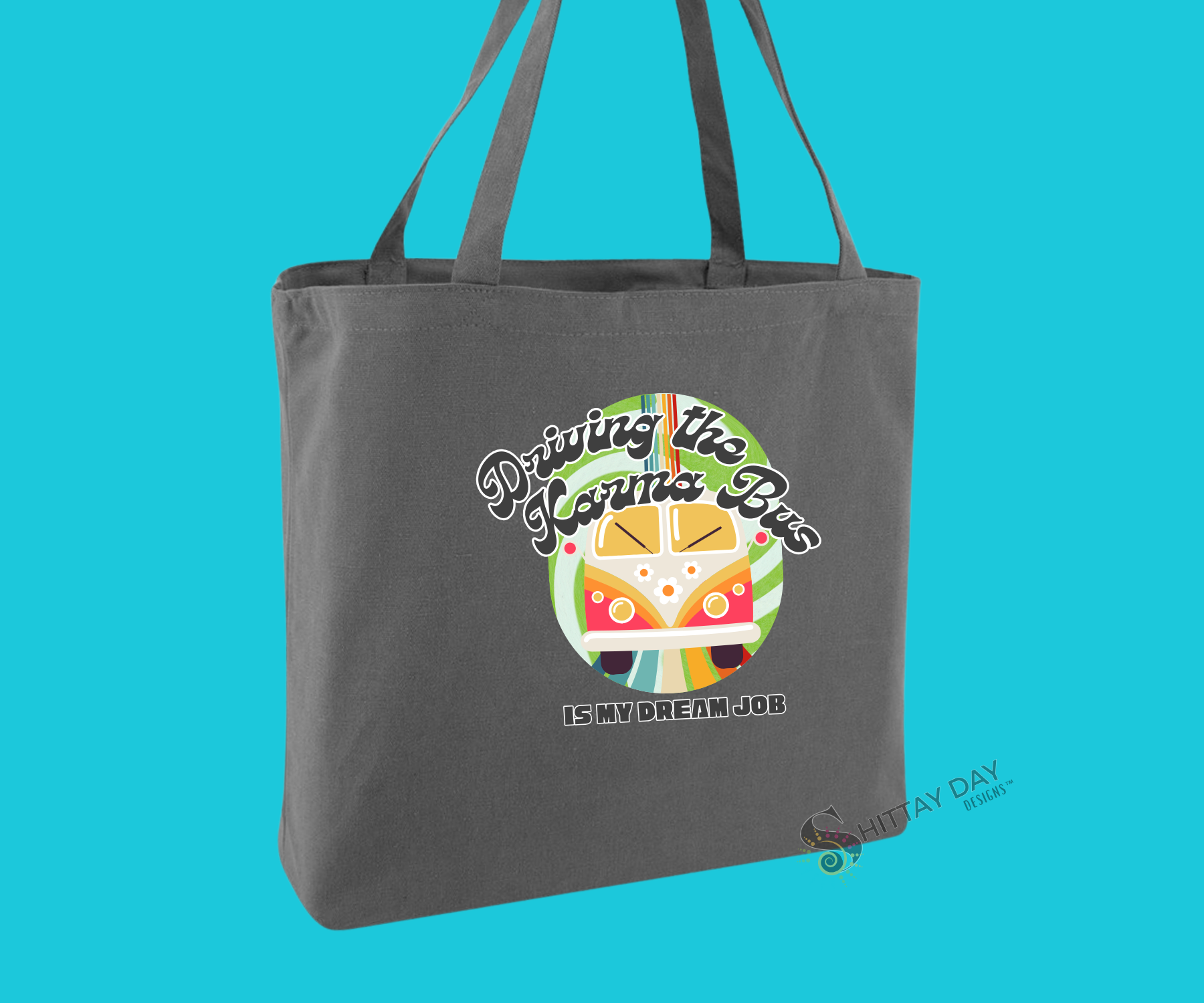 Decorative gray brown tote bag with a colorful graphic of a retro bus, colorful swirl pattern design, and text mock up, merchandised on a blue background