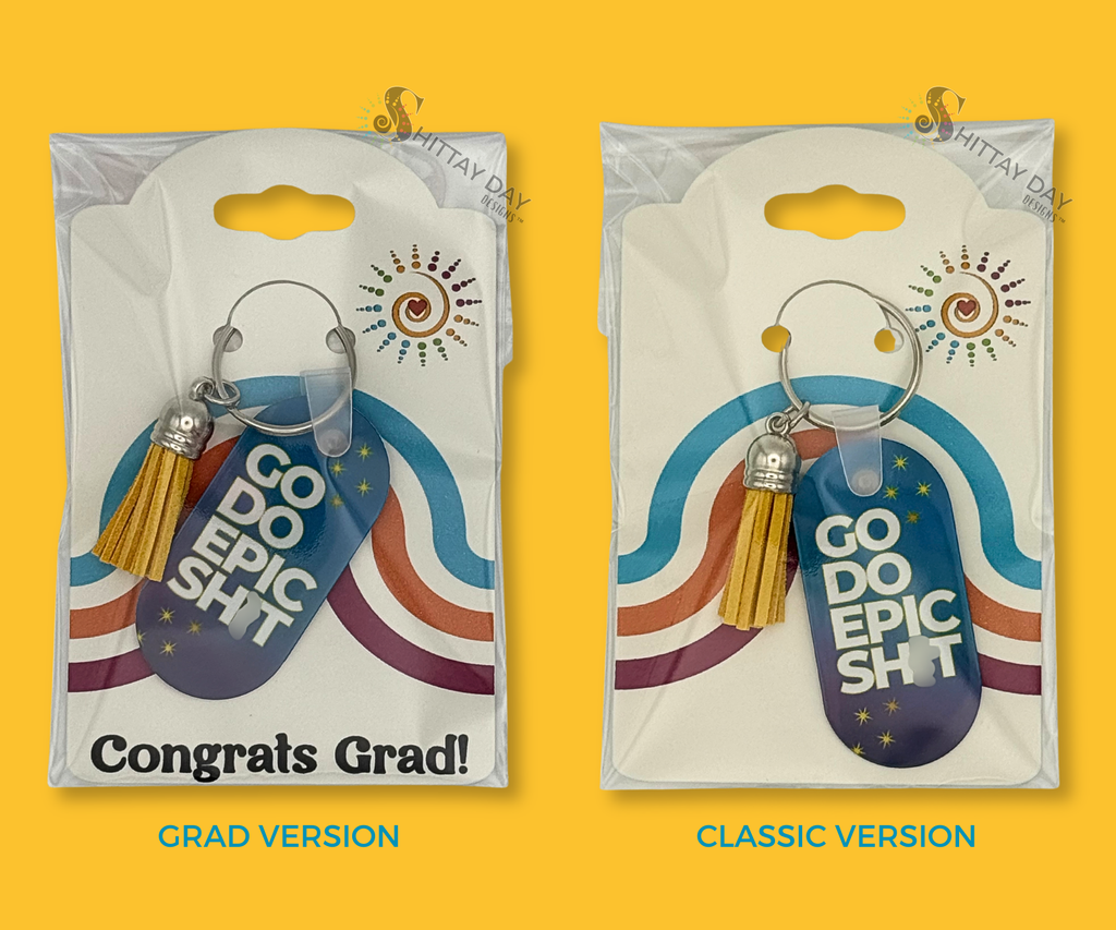 2 keychain versions in clear packaging, with colorful designed back cards, one with Graduation-theme back card that says "congrats grad" and other is standard branded packaging card. The keychains are blue gradient with "Go Do Epic Shit" design text, and yellow stars. The keychain also has a yellow tassel. Images featured on a bright yellow background. 