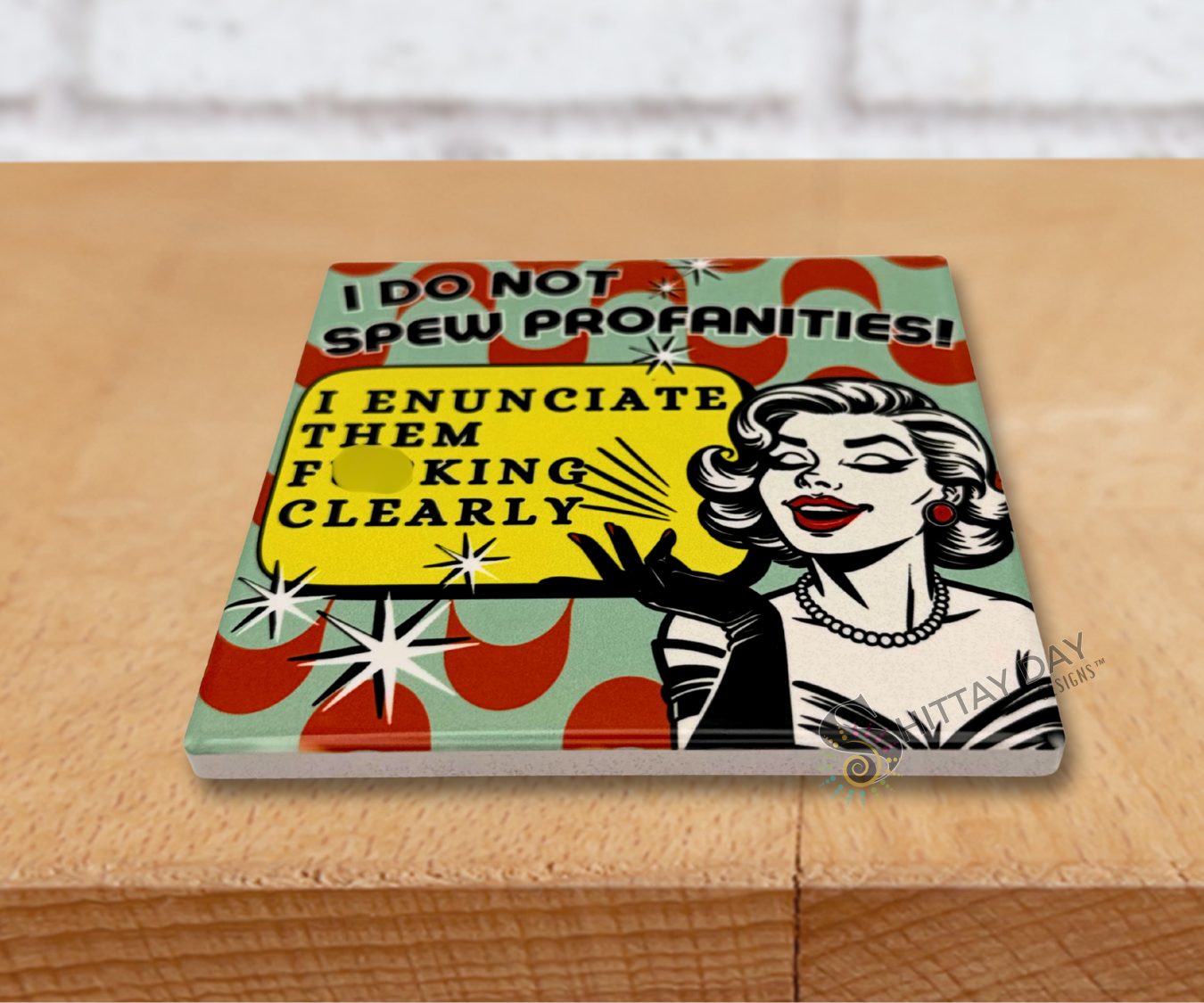 Retro design multicolor ceramic coaster with a graphic design of a woman and the sassy, humorous text 'I Do Not Spew Profanities! I Enunciate Them F*cking Clearly'.
