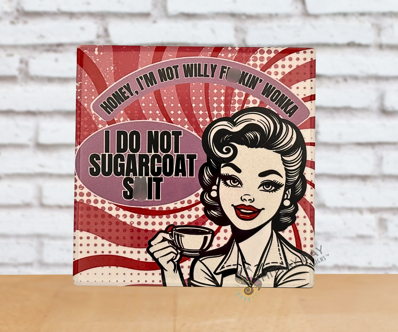 Retro vibe ceramic coaster with a stylized illustration of a woman holding a coffee cup and sarcastic funny text 'Honey, I'm Not Willy F*cking Wonka, I Do Not Sugarcoat Sh*t' on a red and white abstract candy striped background. 