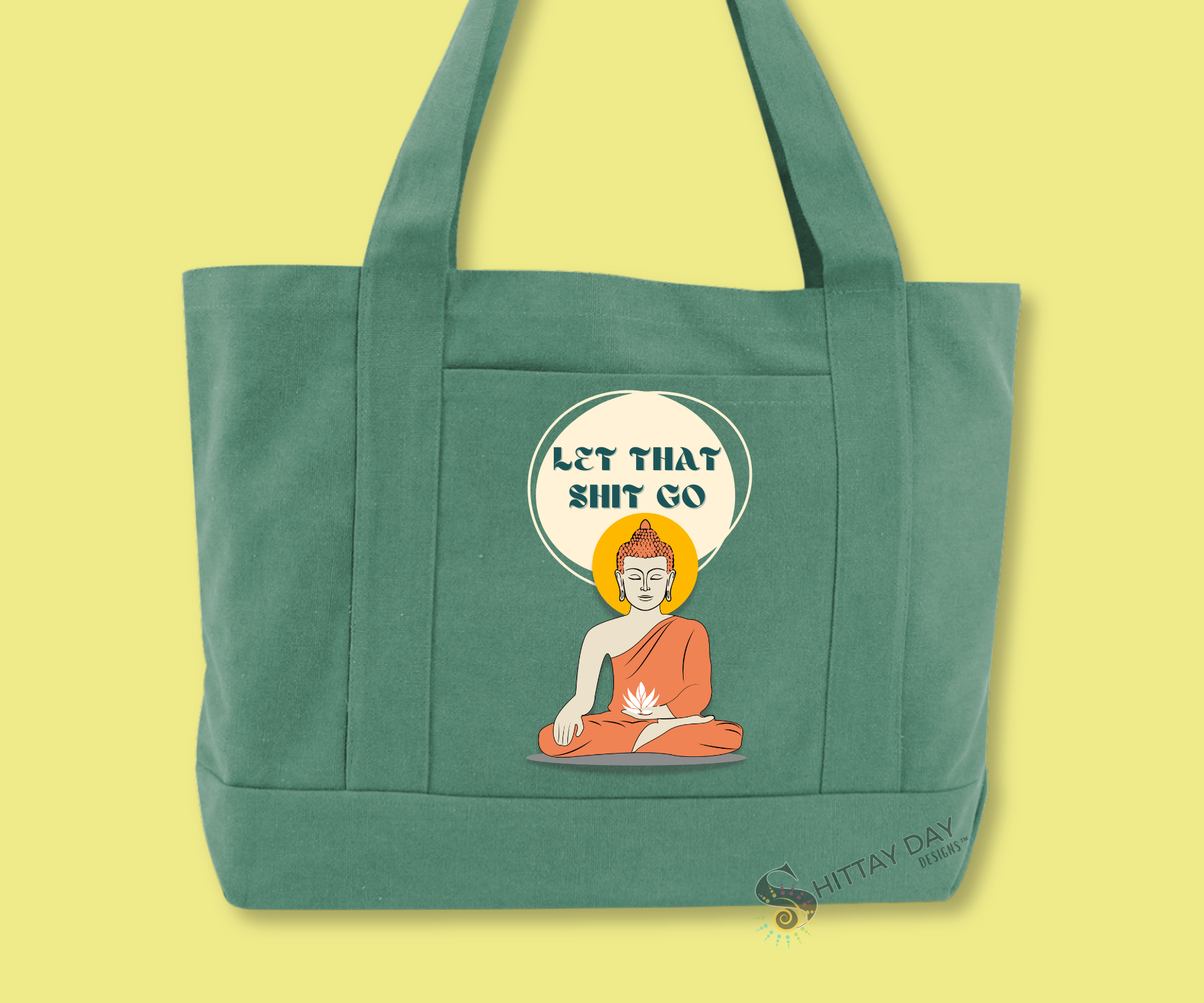 Green pocket tote bag with "let that shit go" text in a circle design featuring the image of a buddha-dharma holding a white lotus flower image.  Merchandised on a light green background.