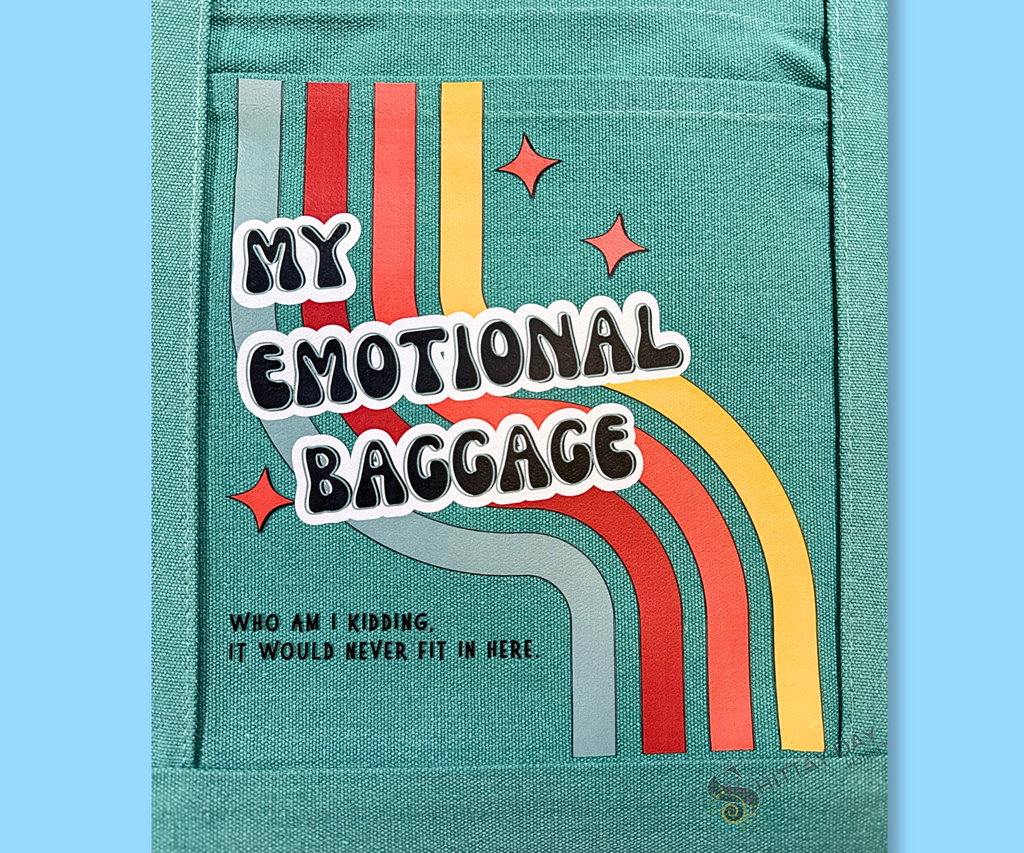 Teal pocket tote close up of design with 'My Emotional Baggage, who am I kidding, it would never fit' text  a multicolor retro stripes, and three orange starbursts. Merchandised on an light blue background.