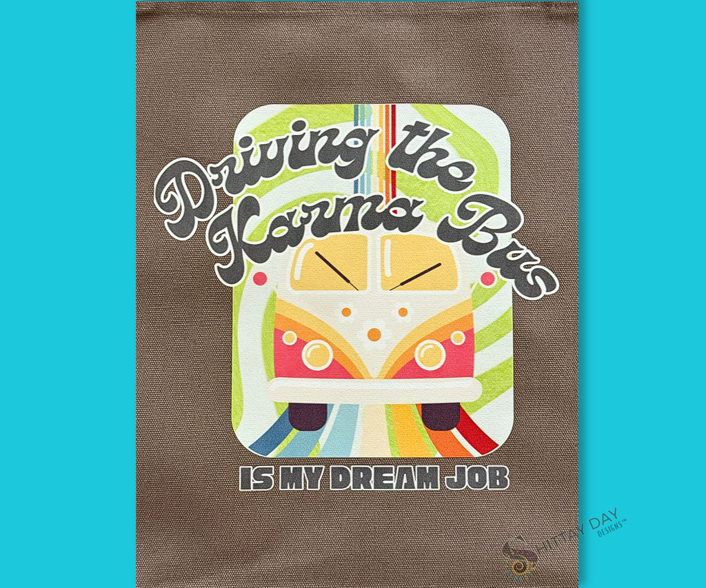 Decorative bag with a colorful graphic of a retro bus, colorful swirl pattern design, and text on a gray brown cloth background