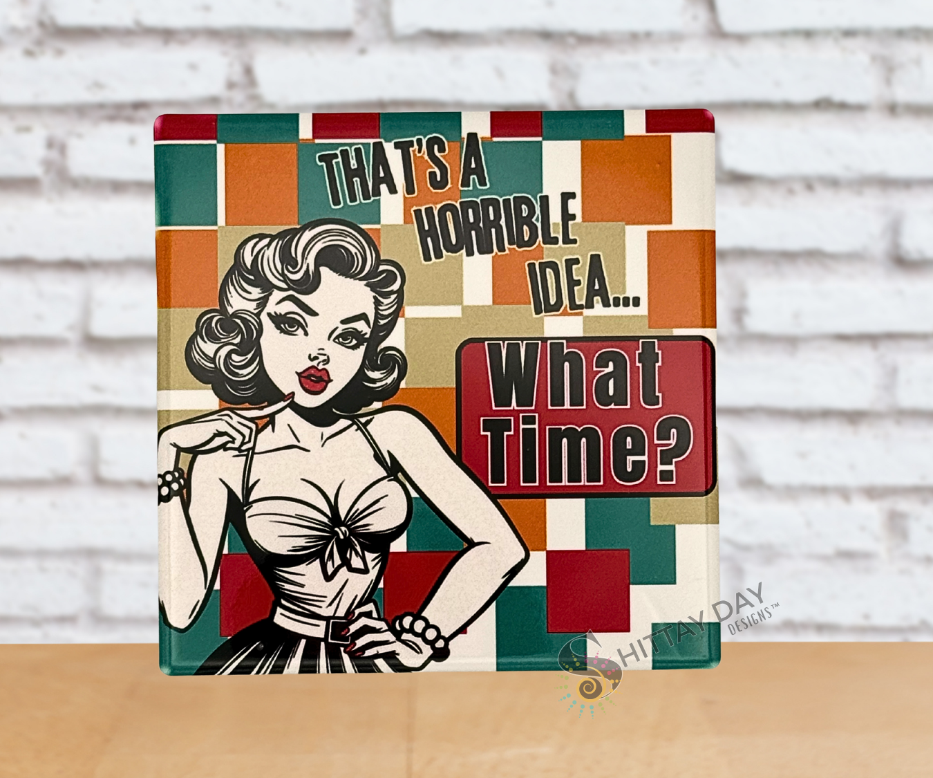 Retro-style pop culture ceramic coaster with a stylized woman and humorous text reading 'That's a Horrible Idea...What Time?' on a color block background