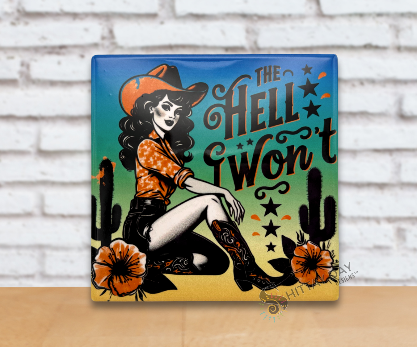 Retro vibe cowgirl on a ceramic coaster and a sassy text reading 'The Hell I Won't' in stylized font, on a gradient colored background with cacti and flowers.