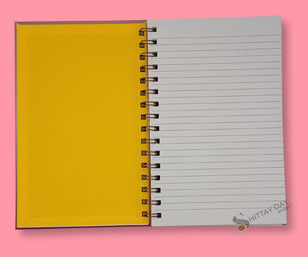 Opened wire bound notebook with yellow inside cover and gray lined pages on a pink background