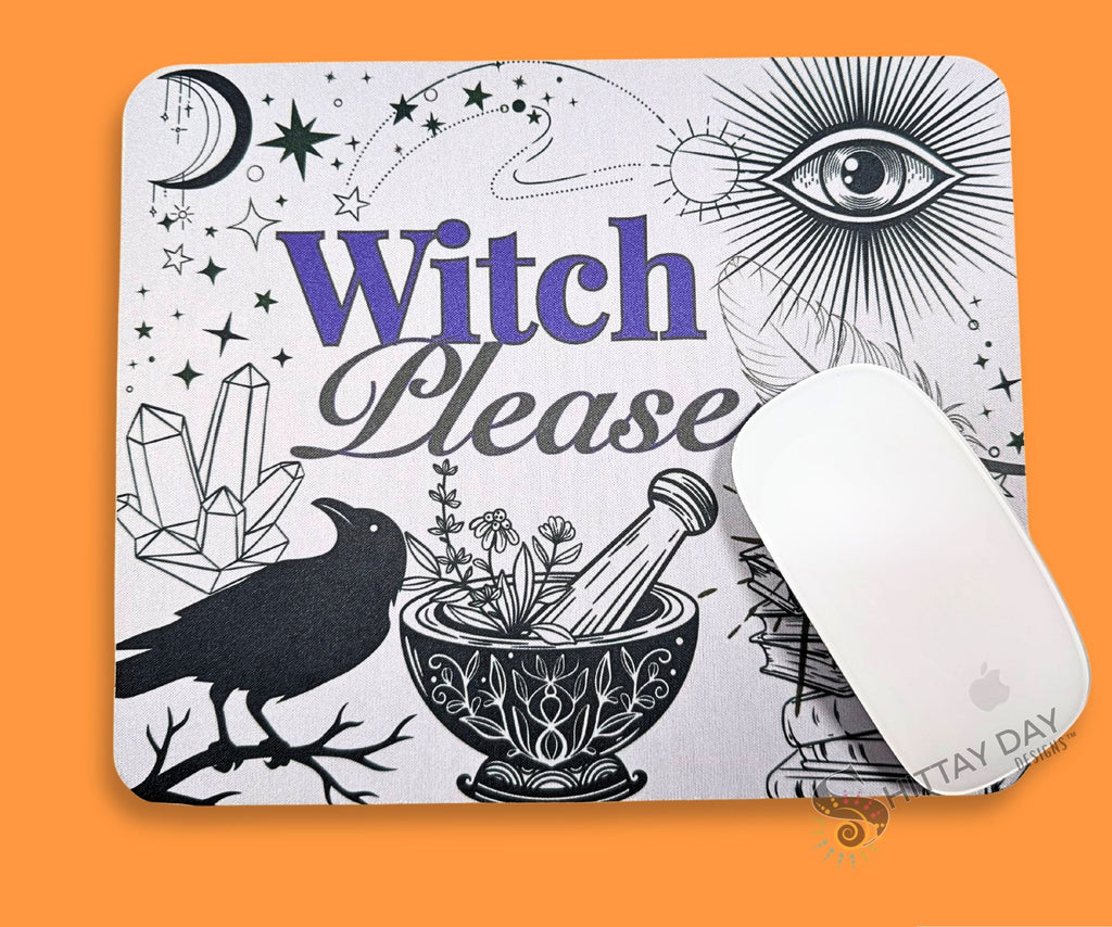 A mouse pad with rfeaturing a white background and black line-art illustrations of a witch, raven, crystals, books, and an eye. The words 'Witch Please' are printed in purple and black across the center. 