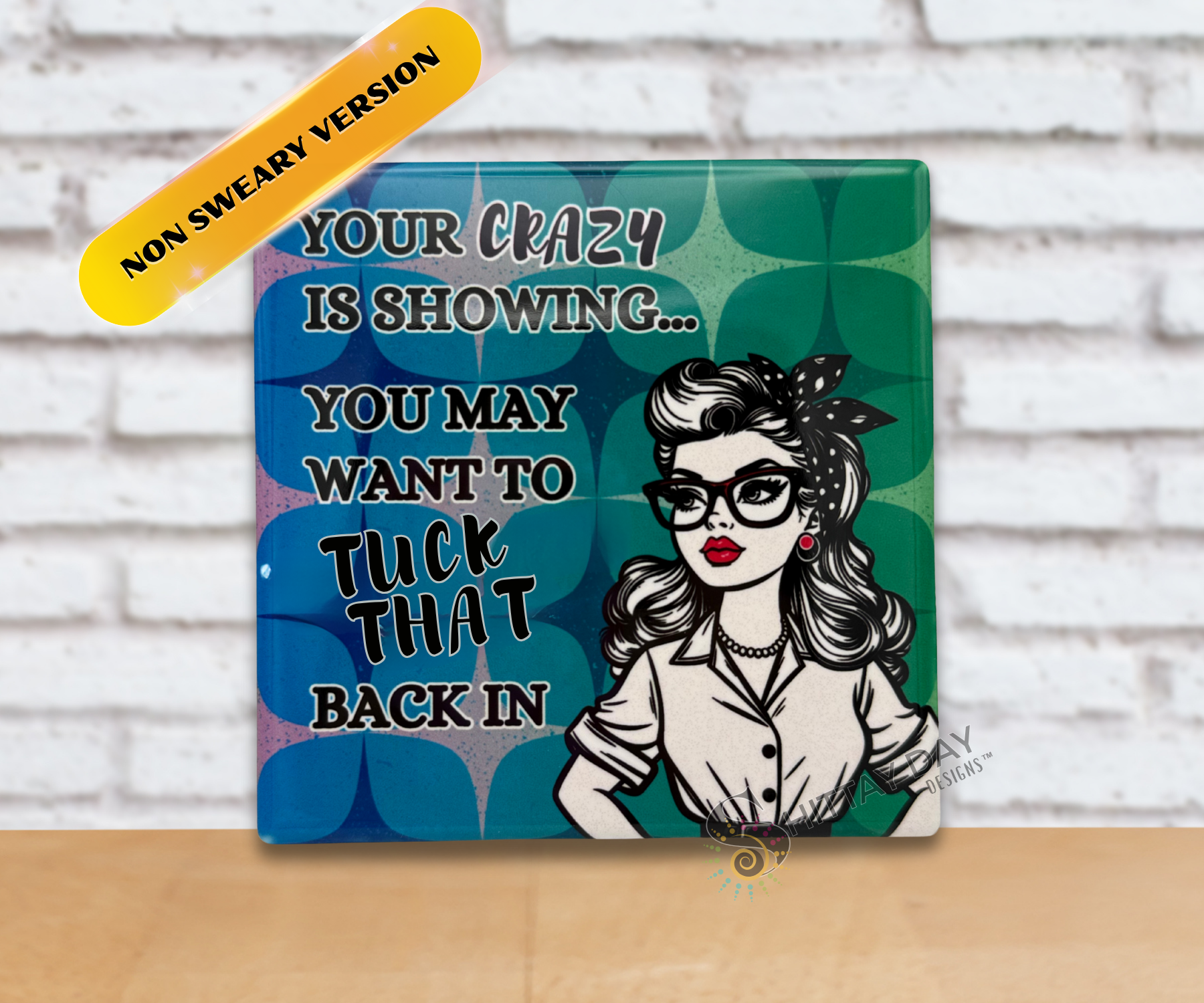 Retro vibe ceramic coaster upright with a woman's illustration and humorous text reading 'Your Crazy Is Showing, You May Want To Tuck That Back in" on a blue and green patterned background.